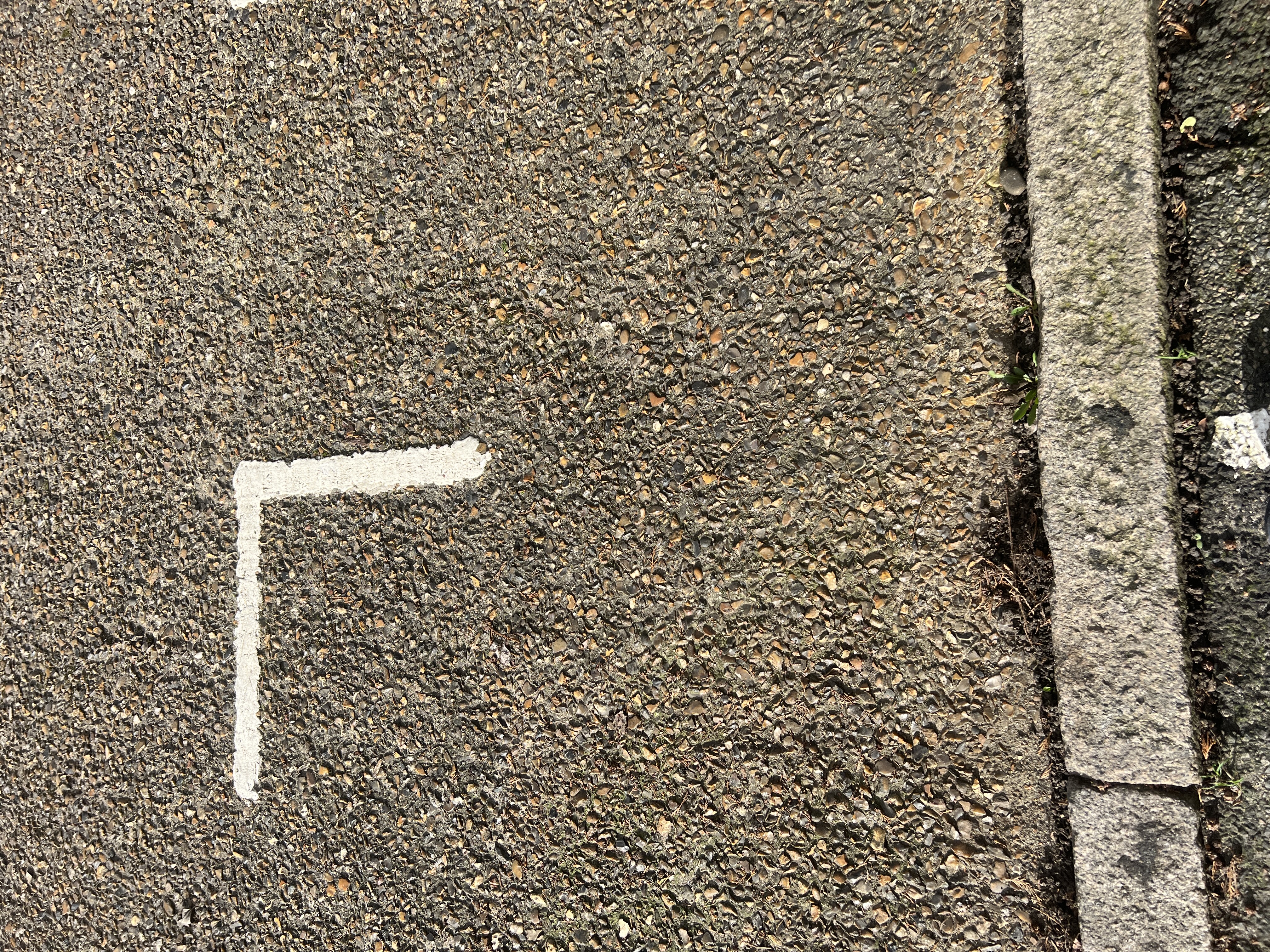 Exposed aggregate concrete surface on Fulwell Park Avenue showing textured road finish