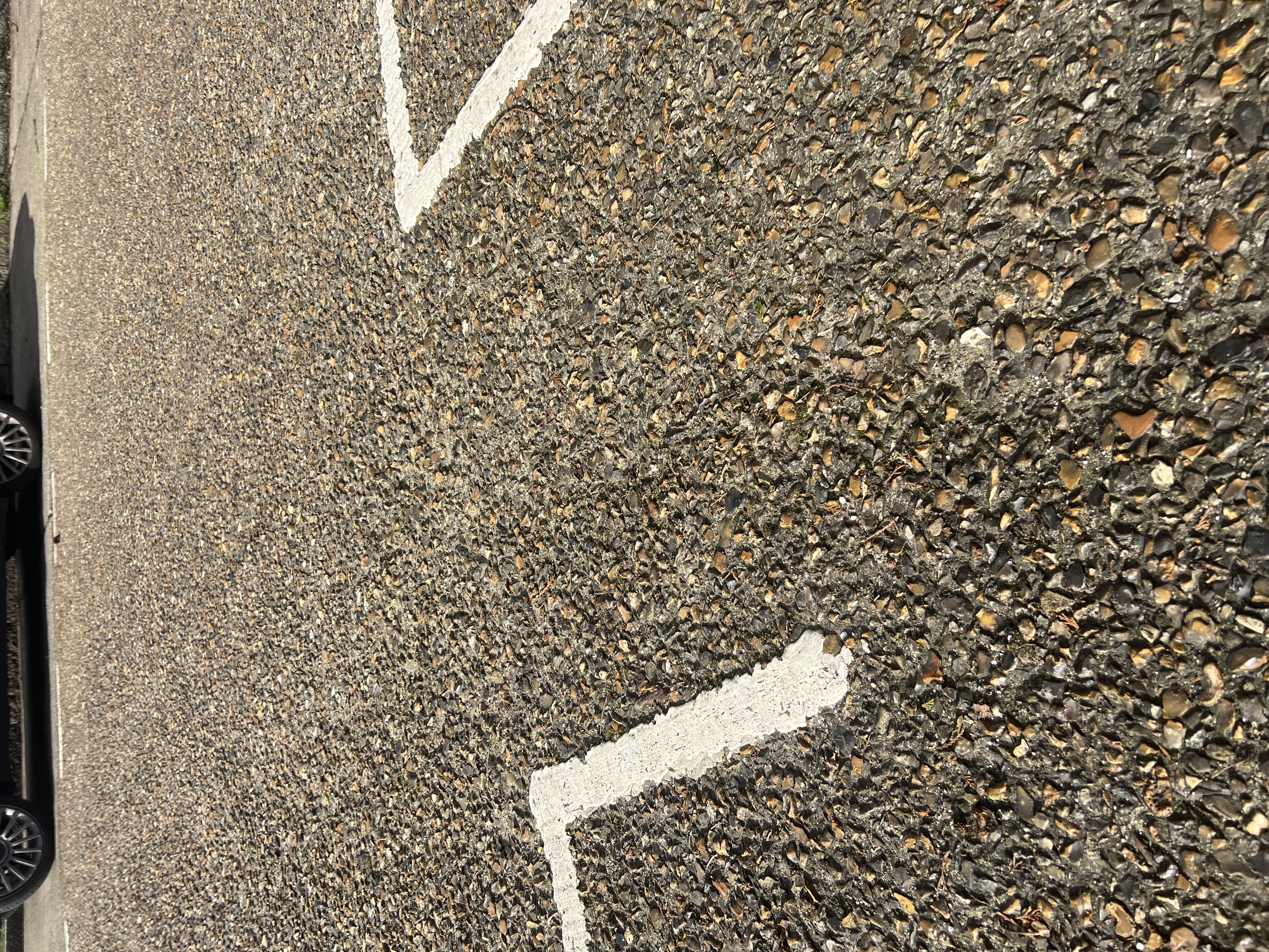 Fulwell Park Avenue road surface with white road markings on aggregate concrete