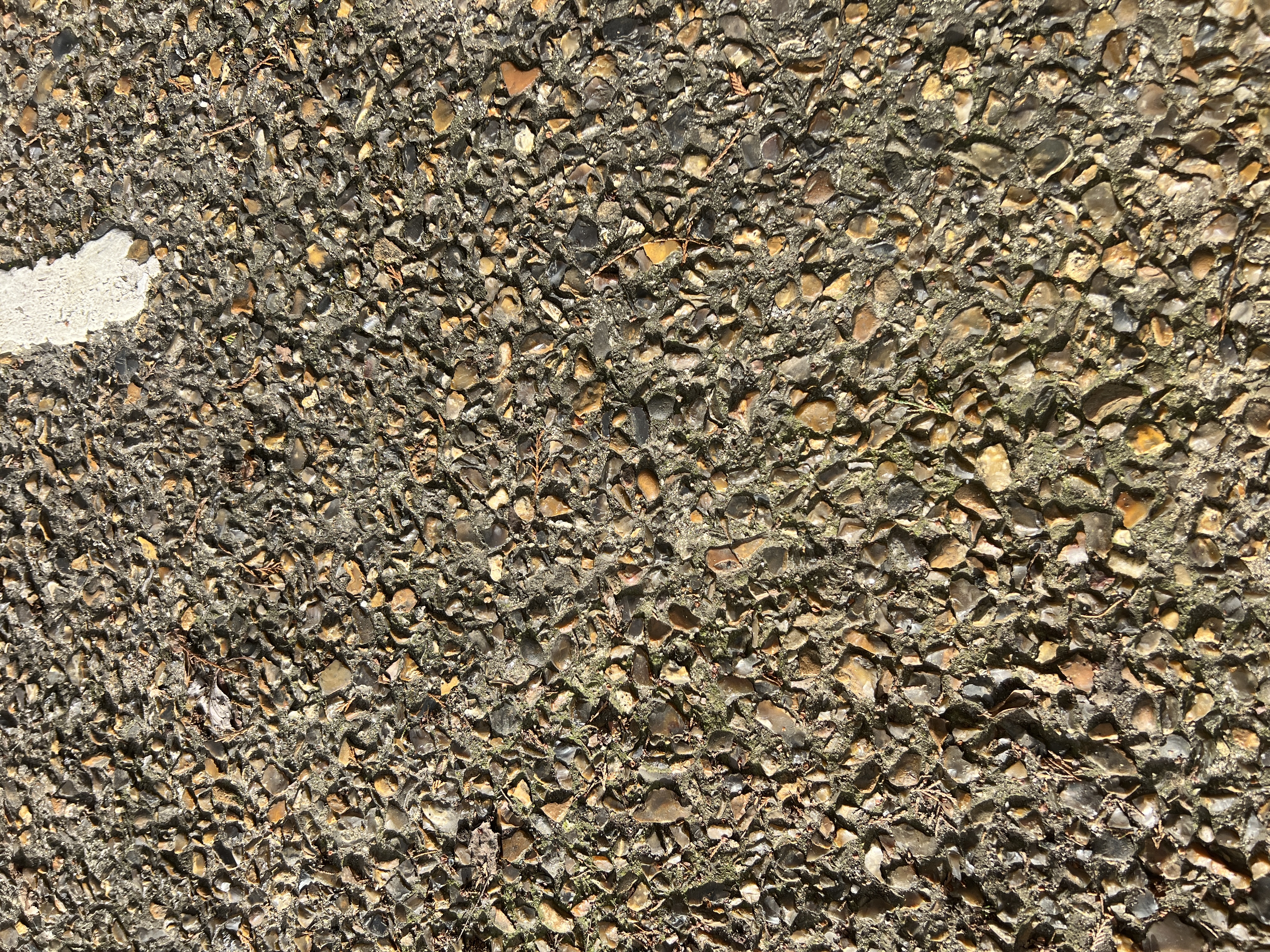 Close-up macro photograph of the exposed aggregate concrete road surface texture