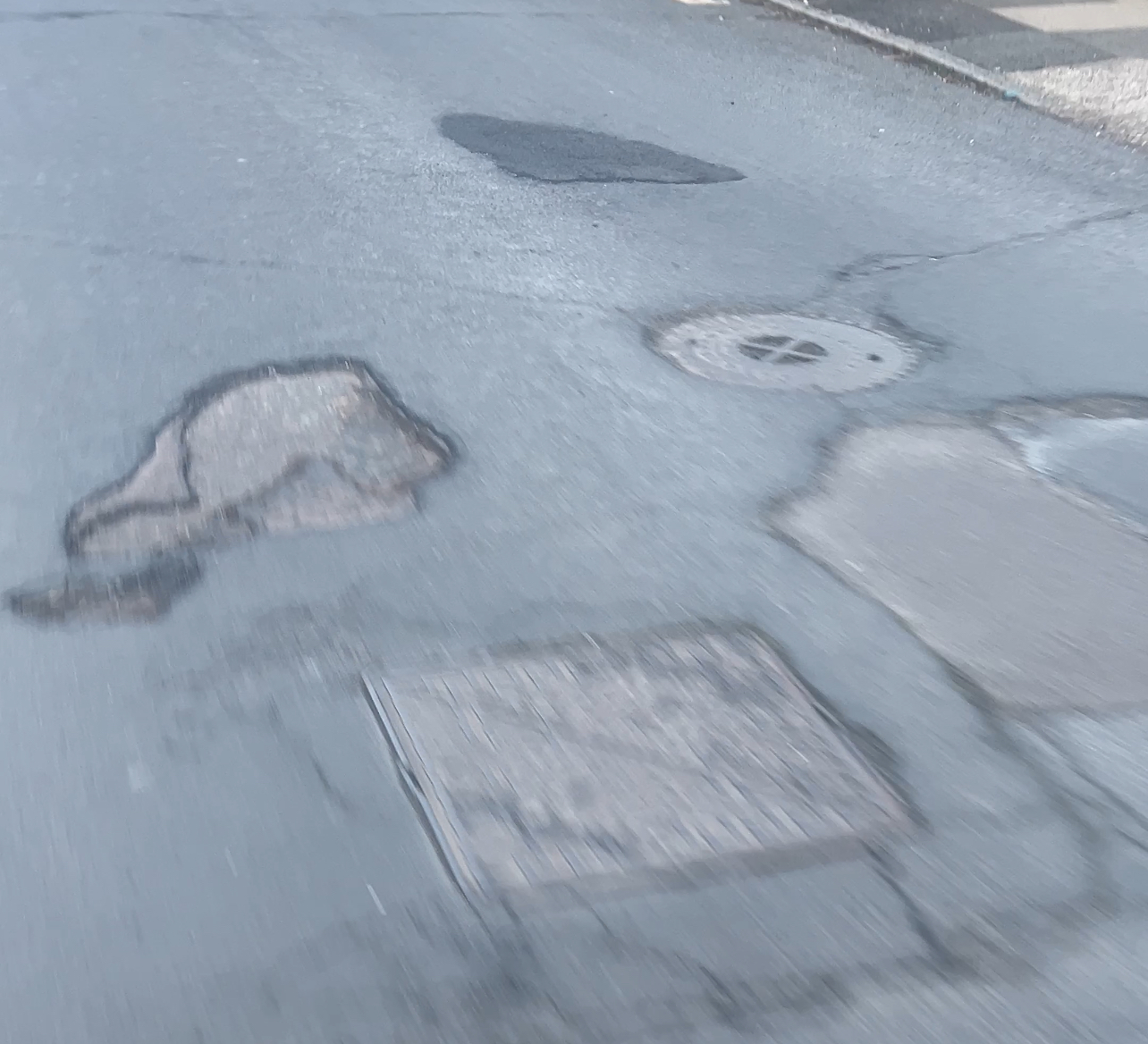 Lincoln Avenue — patch repair visible where a section of asphalt has been removed and resurfaced